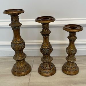 3 resident detailed gold candle holders.
